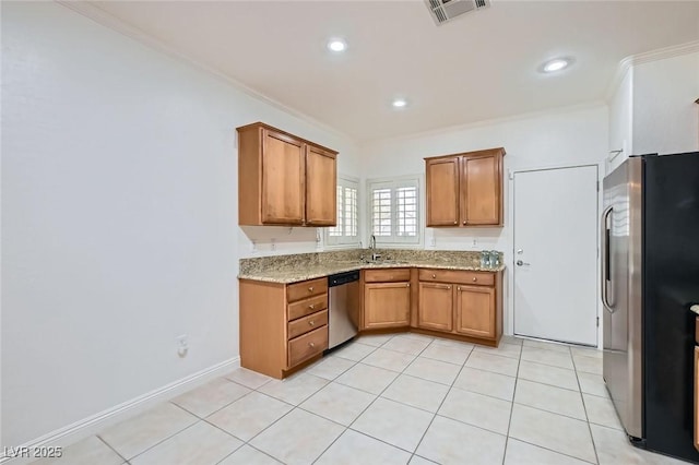 2409 Garganey Ave, North Las Vegas, NV 89084 - kitchen with appliances with stainless steel finishes, a sink, ornamental molding, brown cabinets, and light stone counters