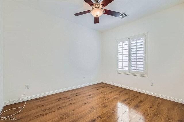 2409 Garganey Ave, North Las Vegas, NV 89084 - unfurnished room featuring baseboards, wood finished floors, and a ceiling fan