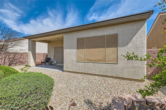 2409 Garganey Ave, North Las Vegas, NV 89084 - back of property with a patio area and stucco siding