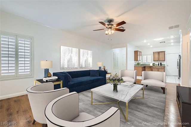 2409 Garganey Ave, North Las Vegas, NV 89084 - living area with a ceiling fan, light wood-style floors, and baseboards