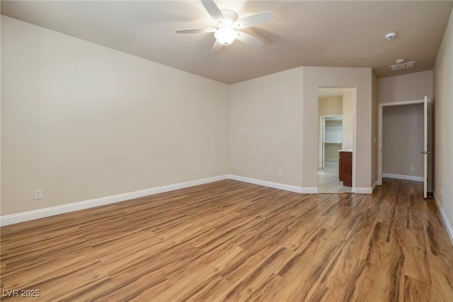 unfurnished bedroom featuring a ceiling fan, baseboards, visible vents, and light wood finished floors