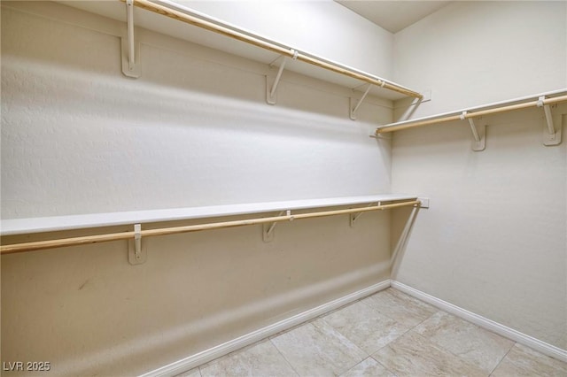 spacious closet with light tile patterned flooring
