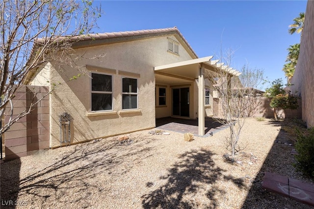 677 Viale Machiavelli Ln, Henderson, NV 89011 - back of house with stucco siding, a fenced backyard, a patio area, and a tiled roof
