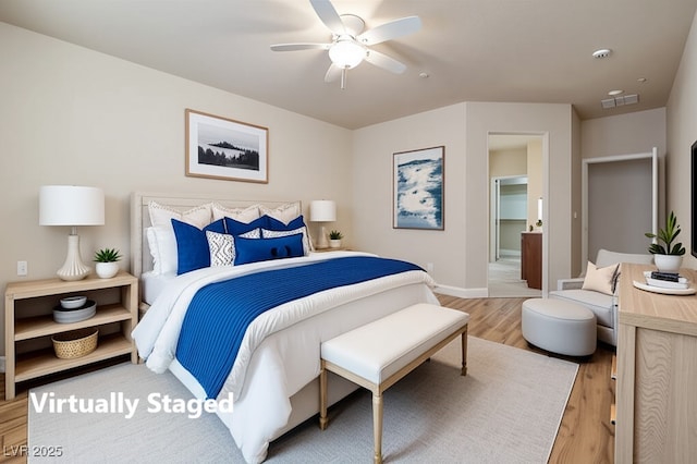 bedroom featuring visible vents, a ceiling fan, baseboards, and light wood-type flooring