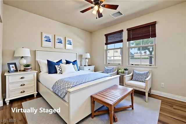 bedroom with baseboards, dark wood-style flooring, and visible vents