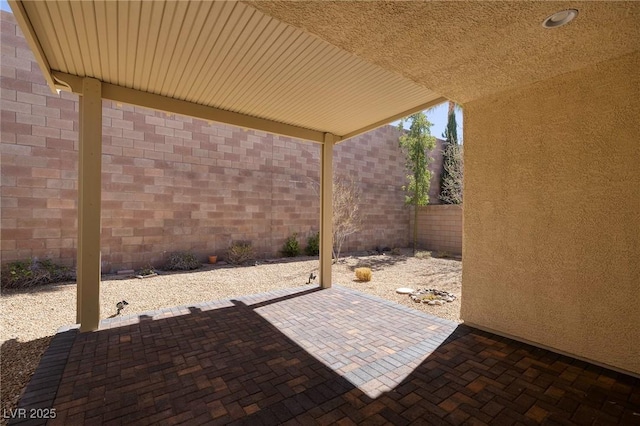 view of patio featuring fence