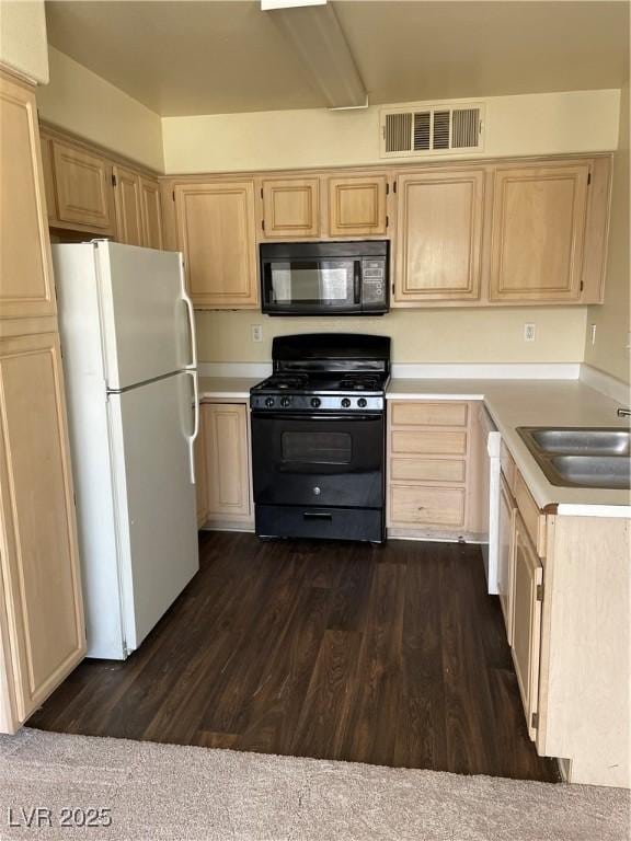 5710 E Tropicana Ave Unit 2033, Las Vegas, NV 89122 - kitchen with light countertops, light brown cabinetry, dark wood-style floors, visible vents, and black appliances
