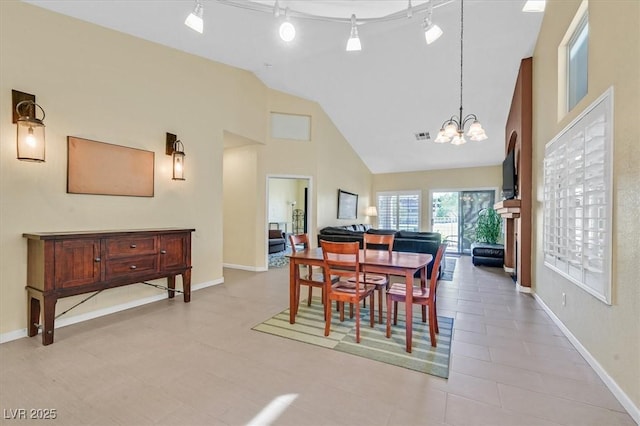 4932 Forest Oaks Dr, Las Vegas, NV 89149 - dining area with a chandelier and high vaulted ceiling