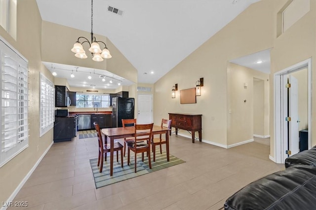 4932 Forest Oaks Dr, Las Vegas, NV 89149 - dining area with a chandelier, high vaulted ceiling, and light tile patterned floors