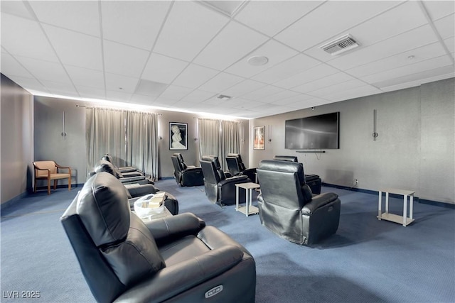 cinema featuring a paneled ceiling, carpet, and visible vents