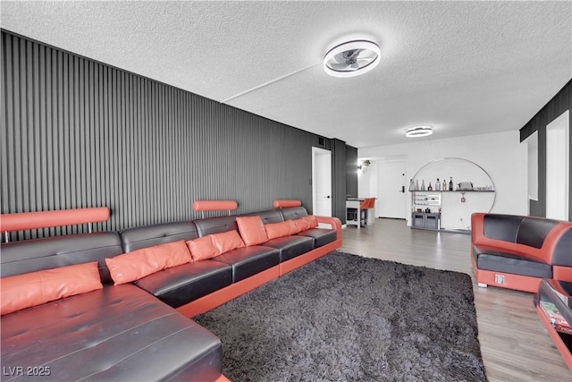 living room featuring a textured ceiling and wood finished floors