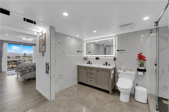 full bathroom with recessed lighting, toilet, a shower stall, a sink, and double vanity