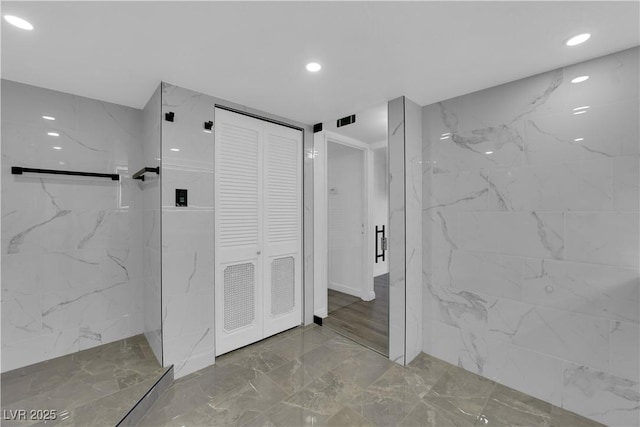 full bathroom featuring a closet, a marble finish shower, marble finish floor, visible vents, and recessed lighting