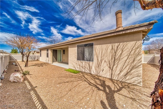 3891 Sedgwick, Pahrump, NV 89061 - rear view of property featuring a fenced backyard, stucco siding, and a patio area