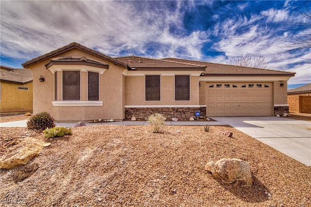 3891 Sedgwick, Pahrump, NV 89061 - view of front of home featuring stone siding, a tiled roof, a garage, stucco siding, and driveway