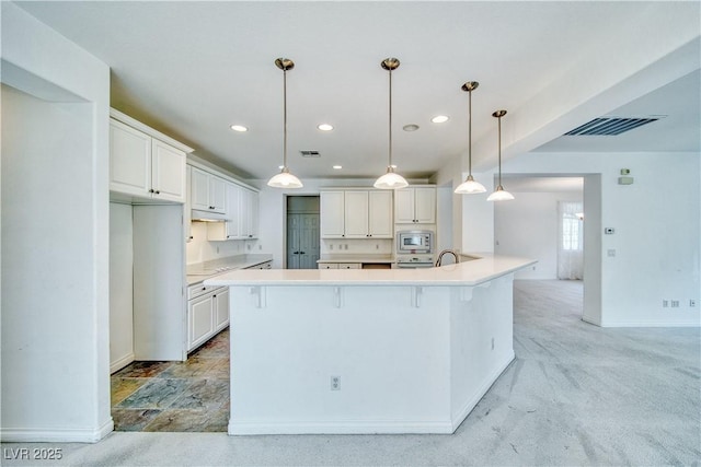 3891 Sedgwick, Pahrump, NV 89061 - kitchen with visible vents, white cabinets, stainless steel microwave, and under cabinet range hood
