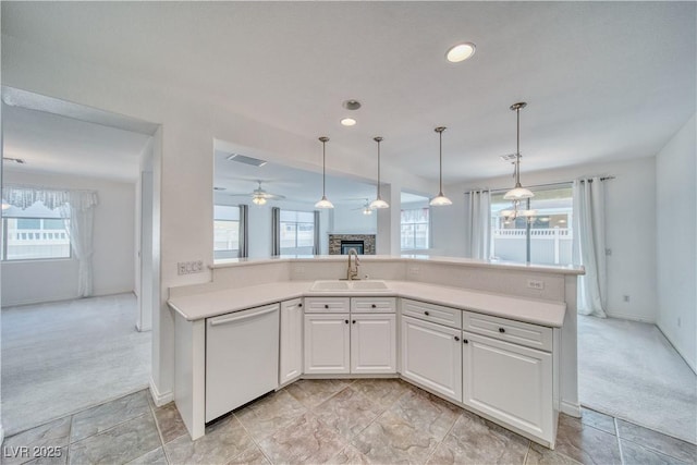 3891 Sedgwick, Pahrump, NV 89061 - kitchen with light colored carpet, a fireplace, a sink, and dishwasher