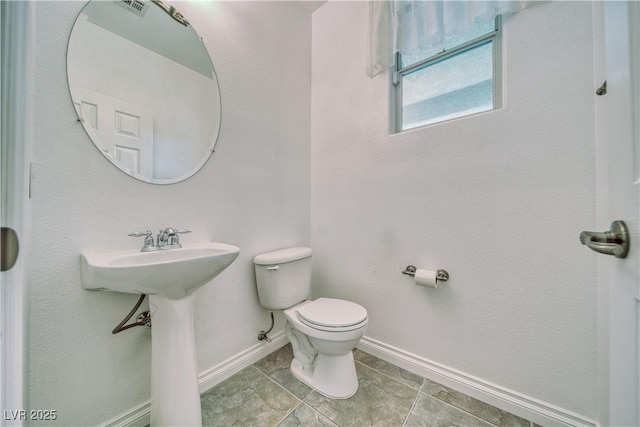 3891 Sedgwick, Pahrump, NV 89061 - bathroom with baseboards, toilet, and tile patterned floors