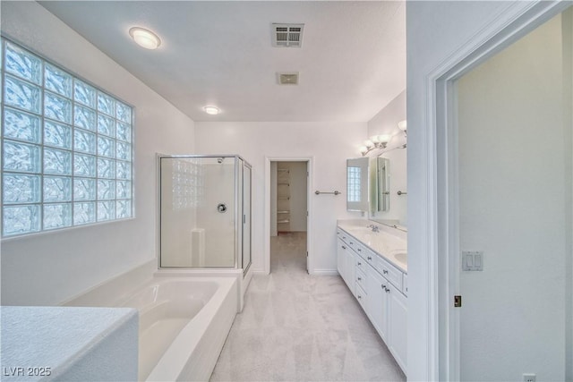 3891 Sedgwick, Pahrump, NV 89061 - full bath featuring a garden tub, a shower stall, a walk in closet, visible vents, and double vanity