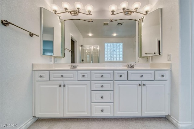 3891 Sedgwick, Pahrump, NV 89061 - bathroom with a stall shower, a sink, baseboards, visible vents, and double vanity