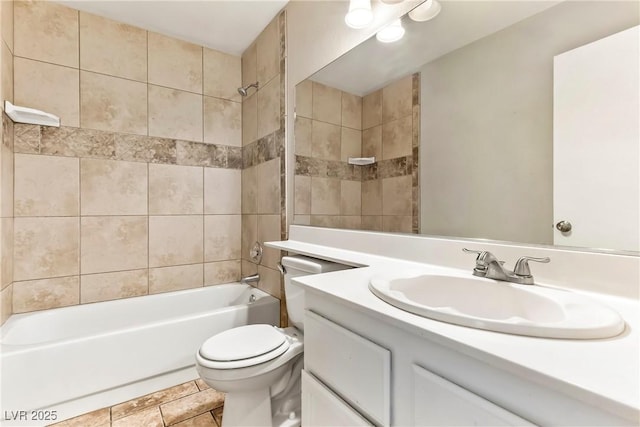 bathroom featuring toilet, vanity, tile patterned floors, and shower / tub combination