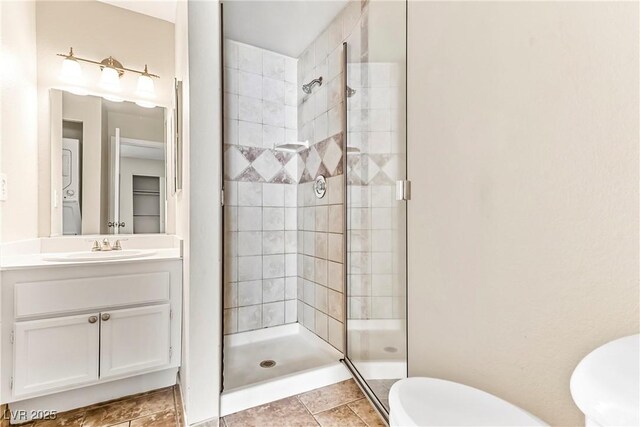 full bathroom featuring vanity, toilet, and a stall shower