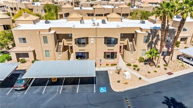 view of property featuring uncovered parking and a residential view