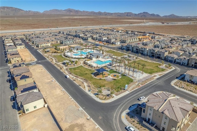 6952 Crimson Shadow St, North Las Vegas, NV 89086 - aerial overview of property's location with a mountainous background, a pool, and nearby suburban area