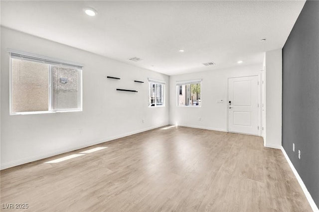 unfurnished room with light wood-style flooring, baseboards, and recessed lighting