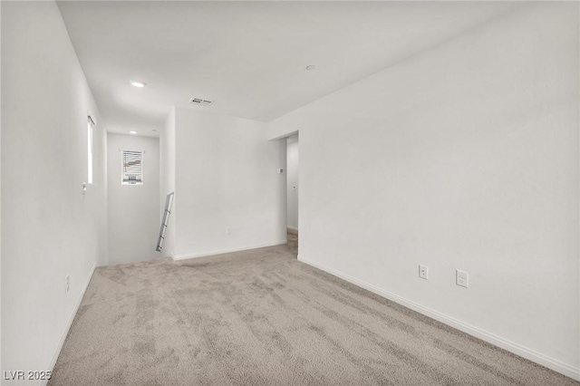 carpeted empty room featuring recessed lighting and baseboards