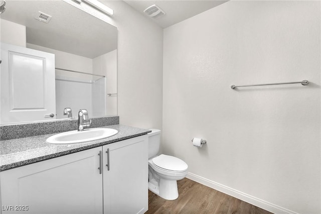 6952 Crimson Shadow St, North Las Vegas, NV 89086 - full bathroom with wood finished floors, baseboards, toilet, and vanity