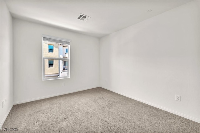 empty room with carpet flooring and baseboards