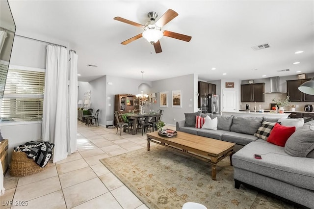 living room featuring ceiling fan with notable chandelier, visible vents, recessed lighting, and light tile patterned floors