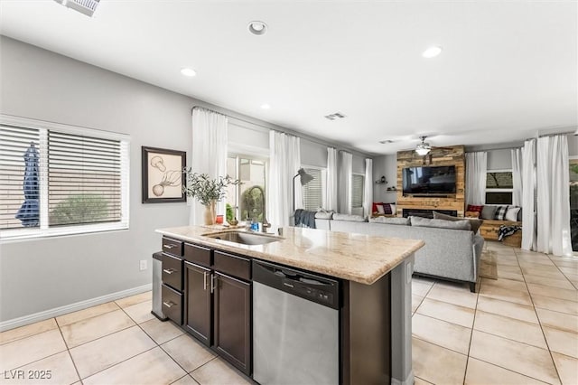 kitchen featuring a sink, a healthy amount of sunlight, stainless steel dishwasher, and light tile patterned floors