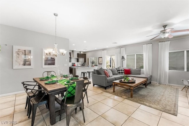 dining room featuring baseboards, recessed lighting, light tile patterned floors, and ceiling fan with notable chandelier