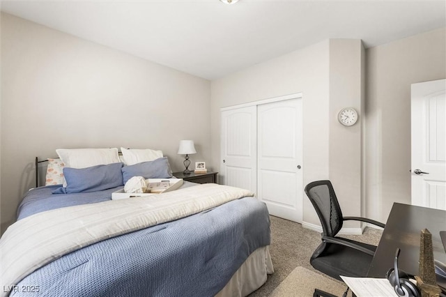carpeted bedroom with baseboards and a closet