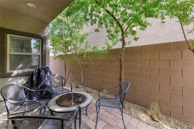 view of patio / terrace featuring a fire pit and fence