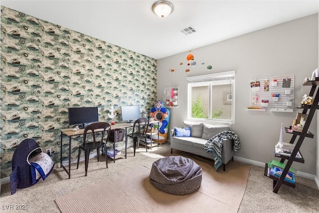 carpeted home office featuring baseboards, visible vents, and wallpapered walls