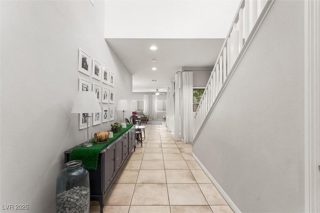 hall featuring baseboards, stairs, recessed lighting, and light tile patterned floors