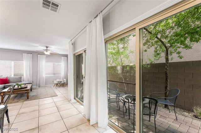 sunroom / solarium featuring visible vents and tile patterned flooring
