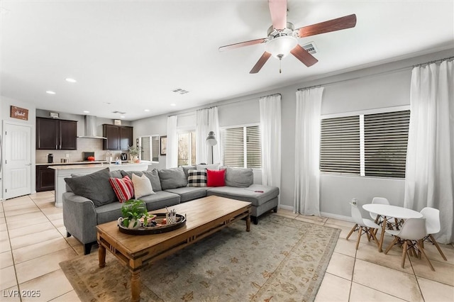 living area featuring visible vents, baseboards, ceiling fan, recessed lighting, and light tile patterned floors