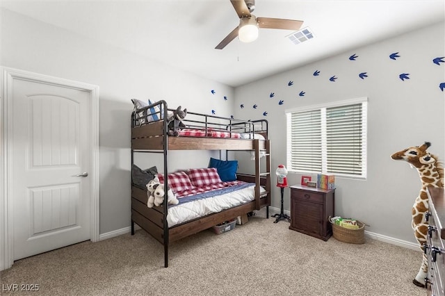 carpeted bedroom with baseboards, visible vents, and a ceiling fan