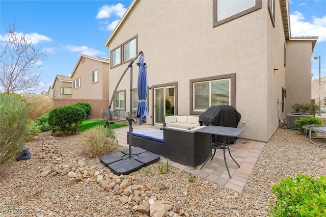 back of property with stucco siding, fence, cooling unit, and a patio area