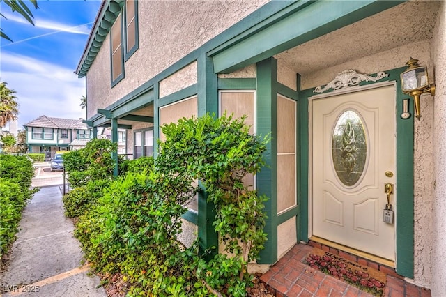 property entrance featuring stucco siding