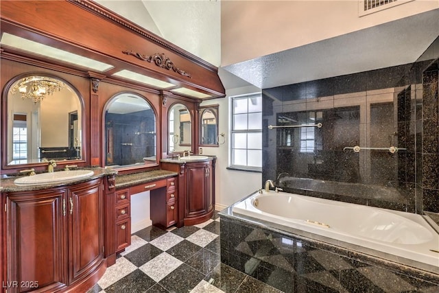 bathroom with a sink, two vanities, a garden tub, granite finish floor, and visible vents