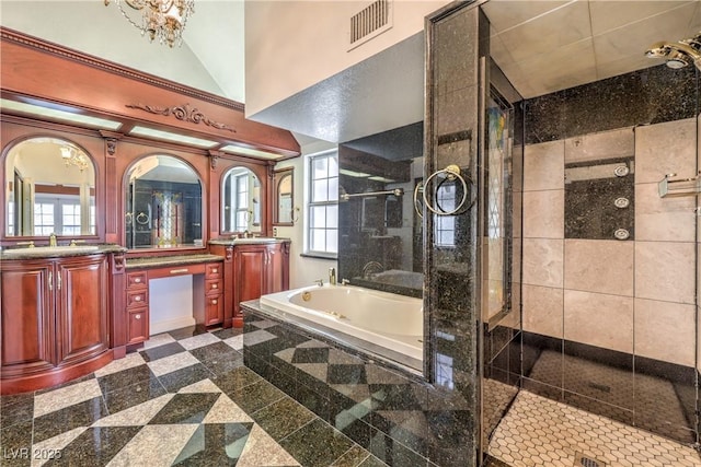 full bathroom with vanity, a shower stall, granite finish floor, a bath, and visible vents