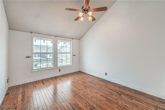 spare room with wood-type flooring, a ceiling fan, baseboards, and lofted ceiling