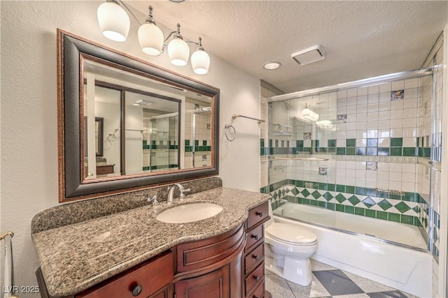 full bath with combined bath / shower with glass door, a textured ceiling, toilet, and vanity