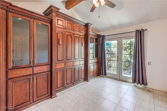 empty room featuring light tile patterned flooring, baseboards, ceiling fan, vaulted ceiling with beams, and french doors