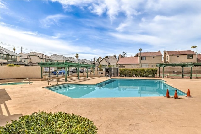 pool with a residential view, a pergola, fence, and a patio area